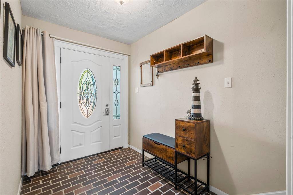 Foyer with mud area and front door lighting