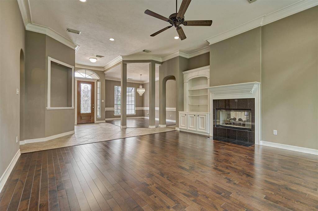 An niche for a favorite piece of art and a cozy fireplace in this spacious formal living room.