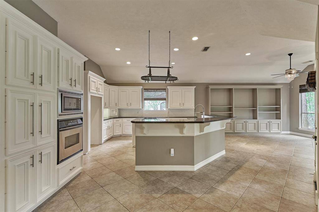 This gourmet kitchen is an entertainer's dream featuring a massive island, stainless steel appliances and storage galore!