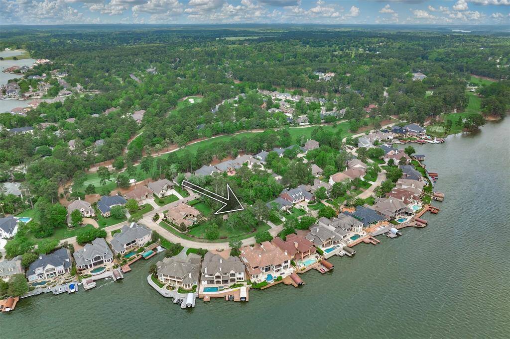 This 4 bedroom, 3 1/2 bath home is nestled in mature trees on a waterfront street.