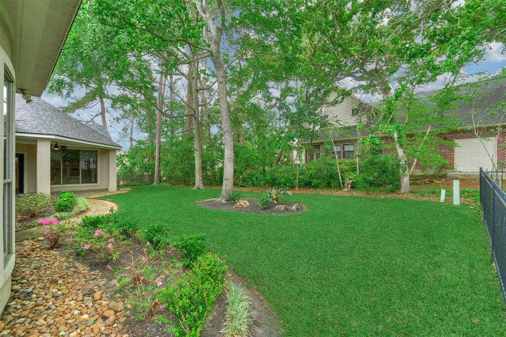 Beautiful landscaping and a luscious green lawn surrounds this stately home.