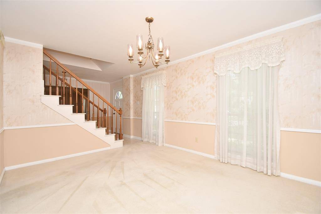 A view from the dining area to the entry and living room.