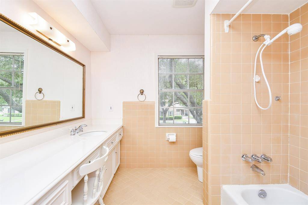 The primary bath has a long vanity and a tub/shower.