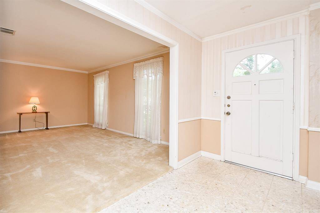 Once inside the home, a living room is on the right and dining room on the left.