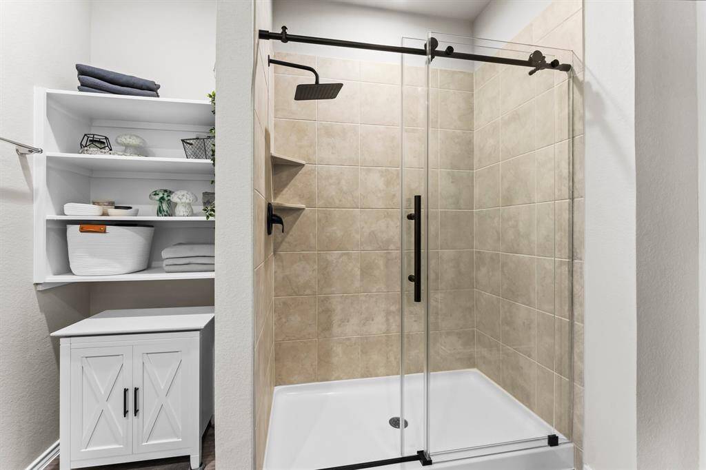 The primary shower has been updated with new hardware and beautiful glass door.  This space is absolutely gorgeous!