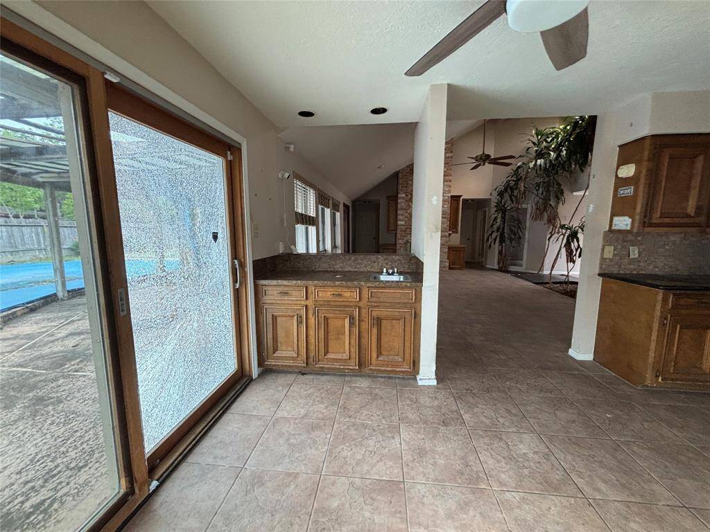 Your breakfast room has easy access to the pool, a beautiful window, and the wet bar.