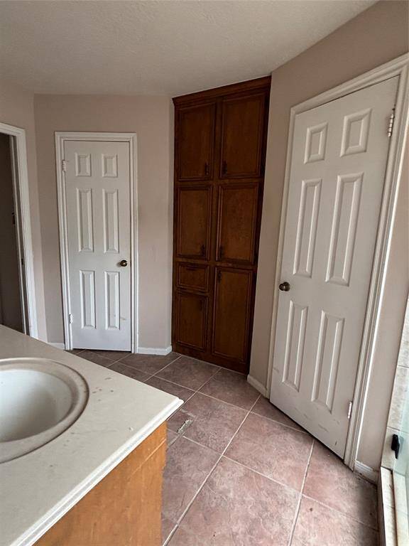 Just as you step in you can notice the two separate walk in closets divided by more cabinet space.