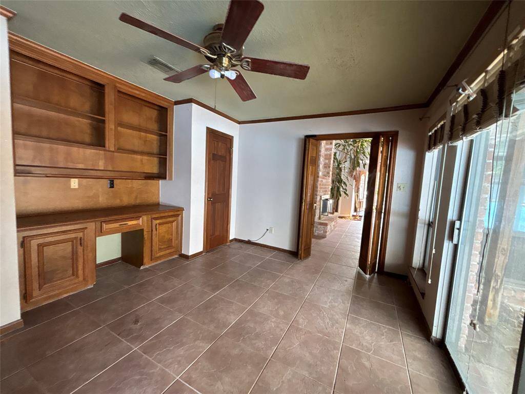 Bedroom 4 has a sliding glass door to the pool area and a built in desk. You have two separate closets to either side of the desk.