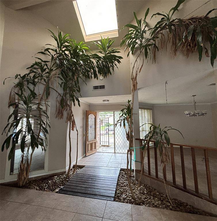 OH!! Look at this entry! It has trees, a bridge, and an abundance of lighting offering such a warm welcome.