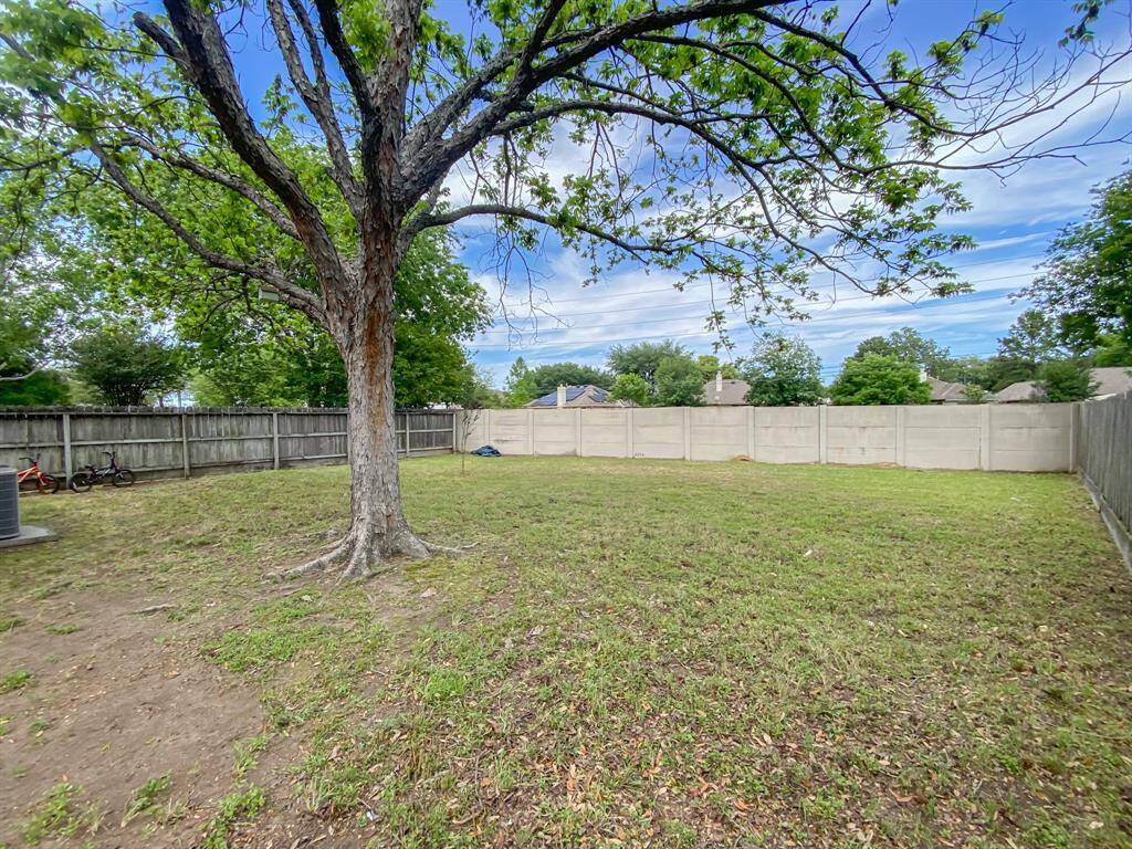 This expansive, fully fenced backyard features beautiful mature trees, offering both privacy and natural beauty.