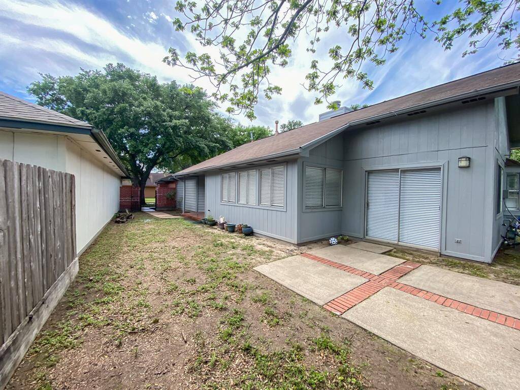 A charming side yard extends from the dining room, seamlessly connecting to the backyard.