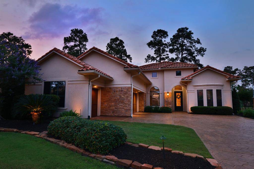 A spacious driveway leads up to a welcoming entrance, highlighted by large arched windows and elegant lighting. HOA includes your gated community and provides maintenance of lawn, patio and common area.