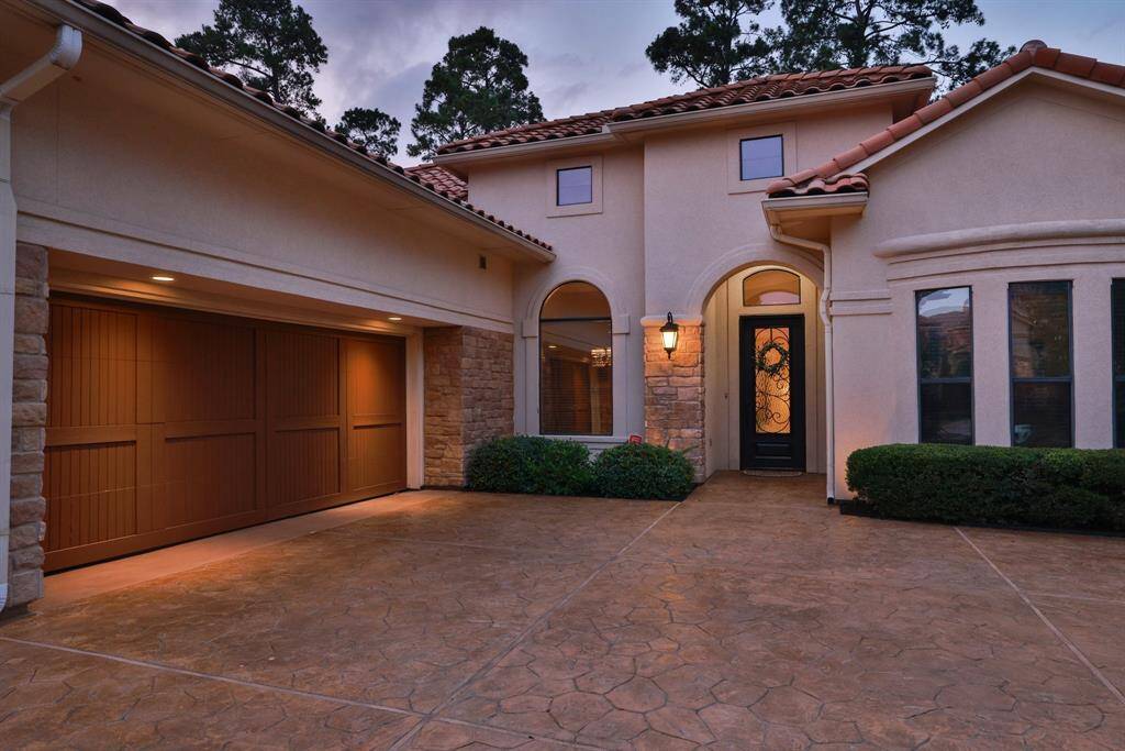 The attached garage and well-maintained landscaping enhance its curb appeal, while the stone accents add a touch of sophistication.