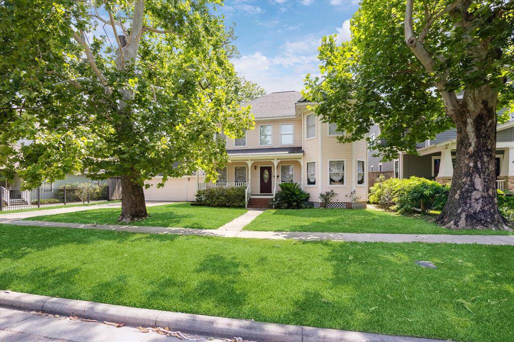 Experience the charming street view of 1620 Columbia, nestled among mature trees and beautifully lush landscaping. This property is situated on an expansive lot in the highly sought-after Houston Heights neighborhood.