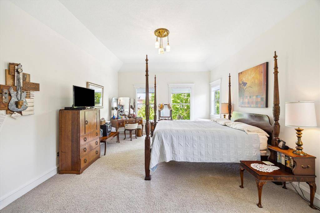 The spacious Primary Bedroom boasts a tray ceiling, multiple windows, abundant natural light, and ample space for your bedroom furniture.