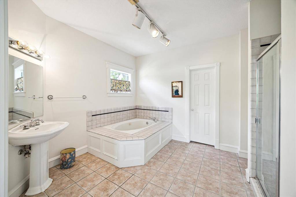 Alternate view of cavernous Primary Bath, featuring separate tub and shower.  Walk in closet photo available upon request.