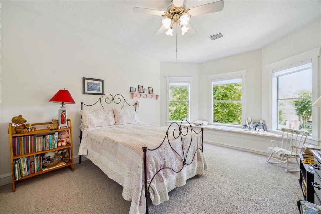 The darling additional secondary bedroom boasts three windows, a charming window seat, and offers generous space.