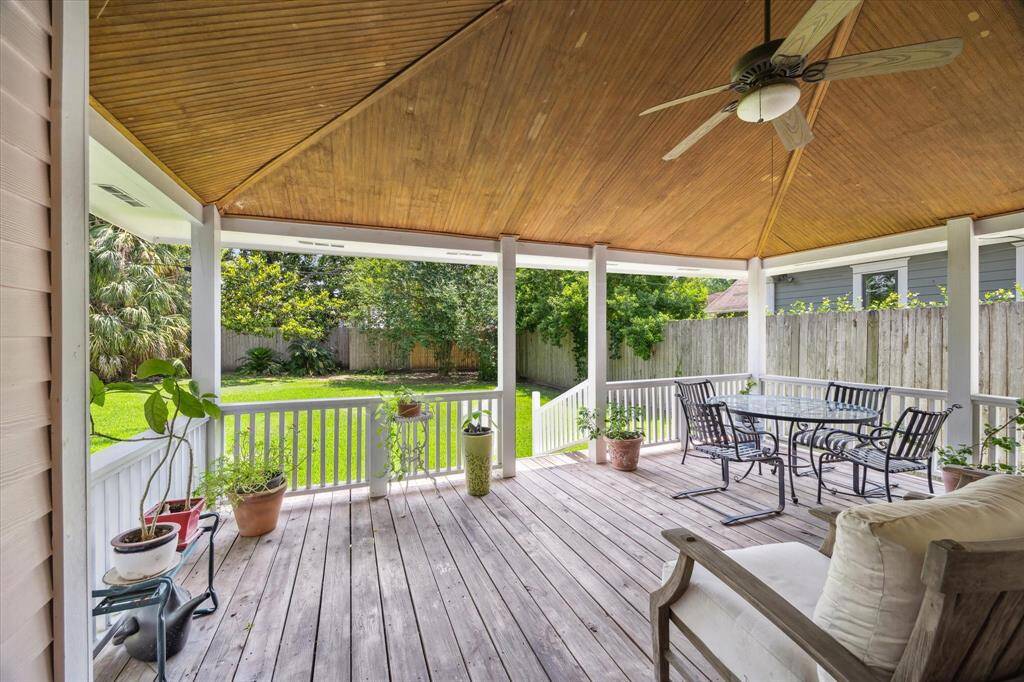 Explore the expansive backyard deck, which is fully covered to provide comfort and shade. The detailed wood ceiling showcases intricate craftsmanship, complemented by an architectural pitch that adds character and style to this outdoor retreat.
