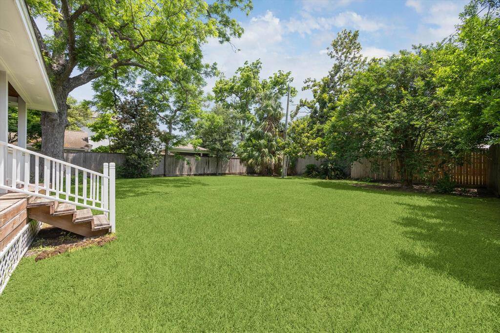 Another captivating view of the stunning yard reveals ample space for a pool or playset, offering endless possibilities for customization and outdoor enjoyment.