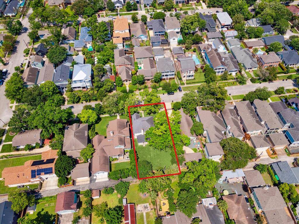 An aerial view of the property showcases the expansive 9,900 square foot lot, highlighting its generous size and potential.