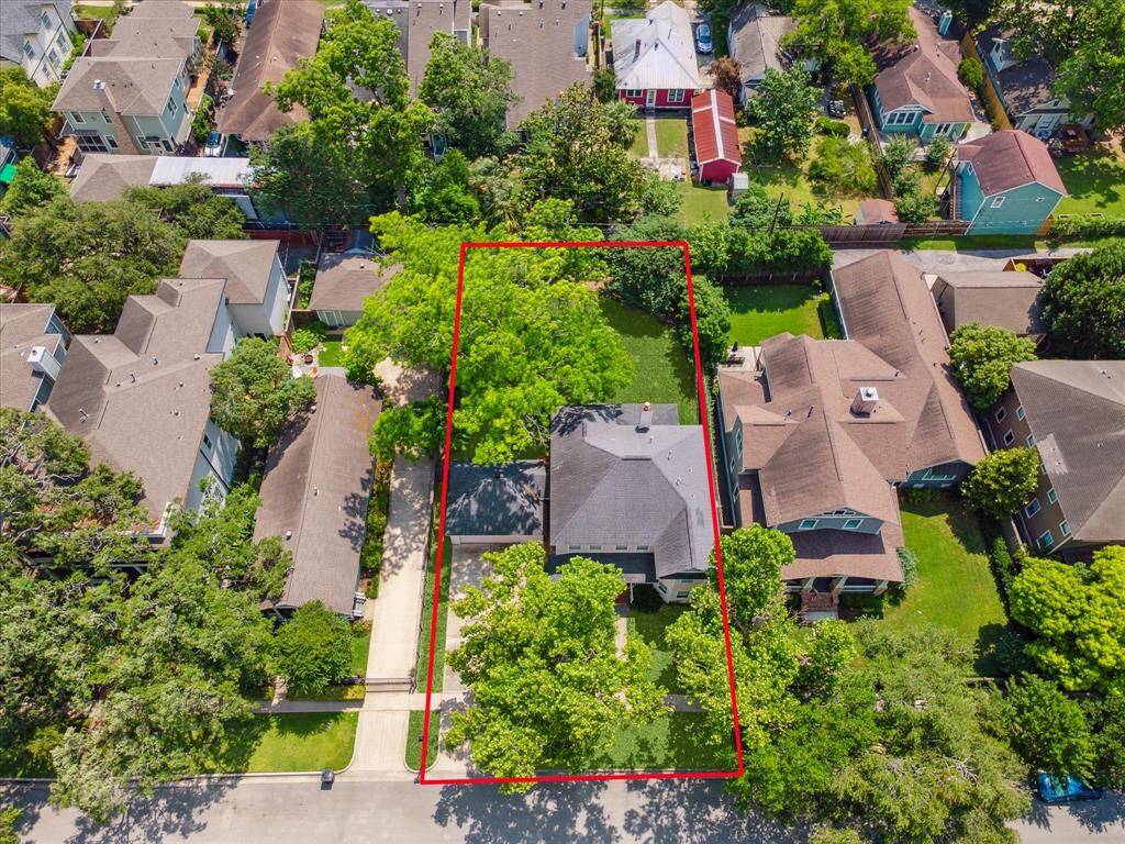 An aerial view of the property showcases the expansive 9,900 square foot lot, highlighting its generous size and potential.