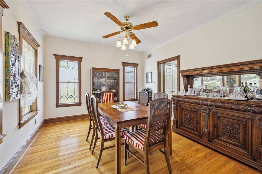 The dedicated Dining Room showcases exquisite windows, high ceilings, oak wood floors, and stunning molding.