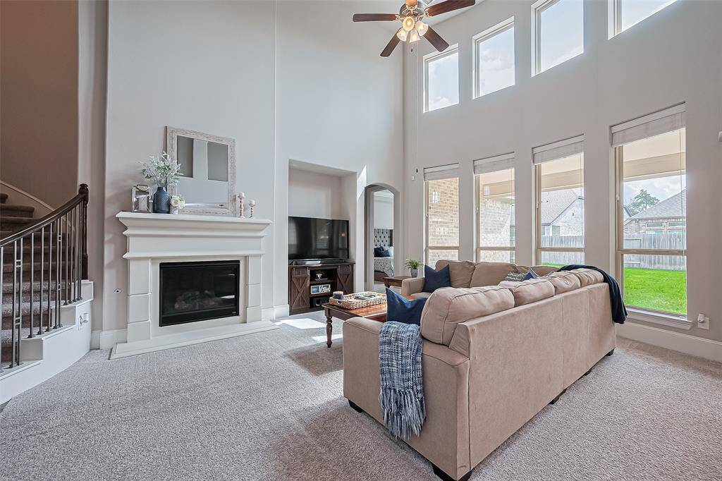 Wow beautiful natural lighting throughout the living room. Enjoy the fireplace with a view.