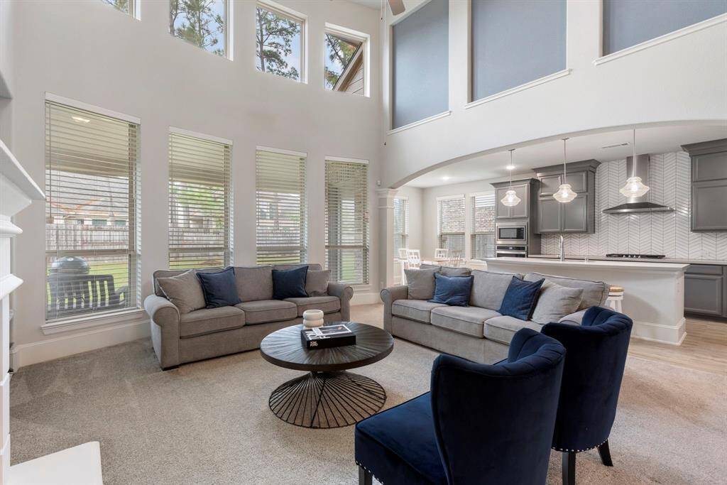 The floor to ceiling windows provide an abundance of light into the space which overlooks the backyard.