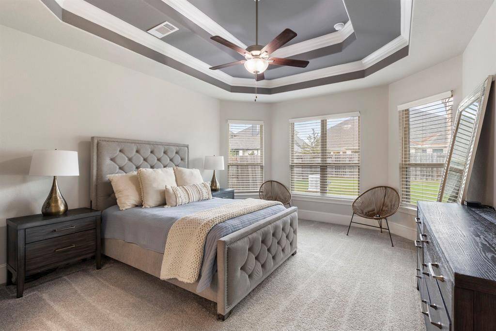 The Primary Bedroom has an unique tiered ceiling and a beautiful bay window.