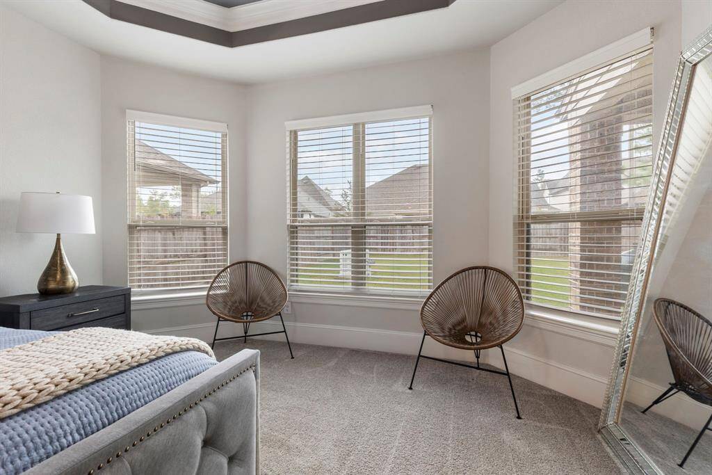 The added space in the Primary bedroom allows the perfect place for a cozy reading spot.