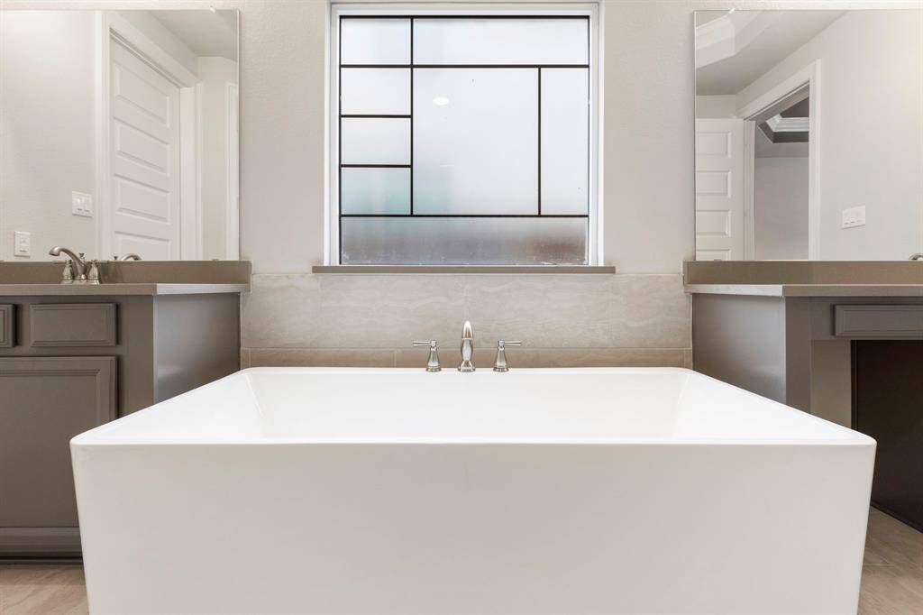 The freestanding tub is the focal point and across from the separate shower.