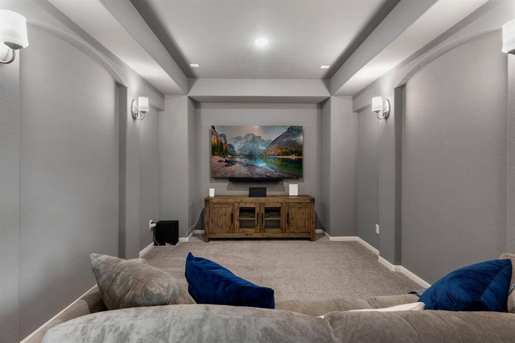 The media room has sconces and is wired for surround sound.