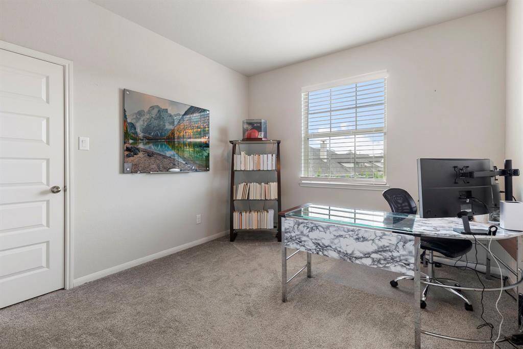 The second bedroom upstairs, currently being used as a second office.