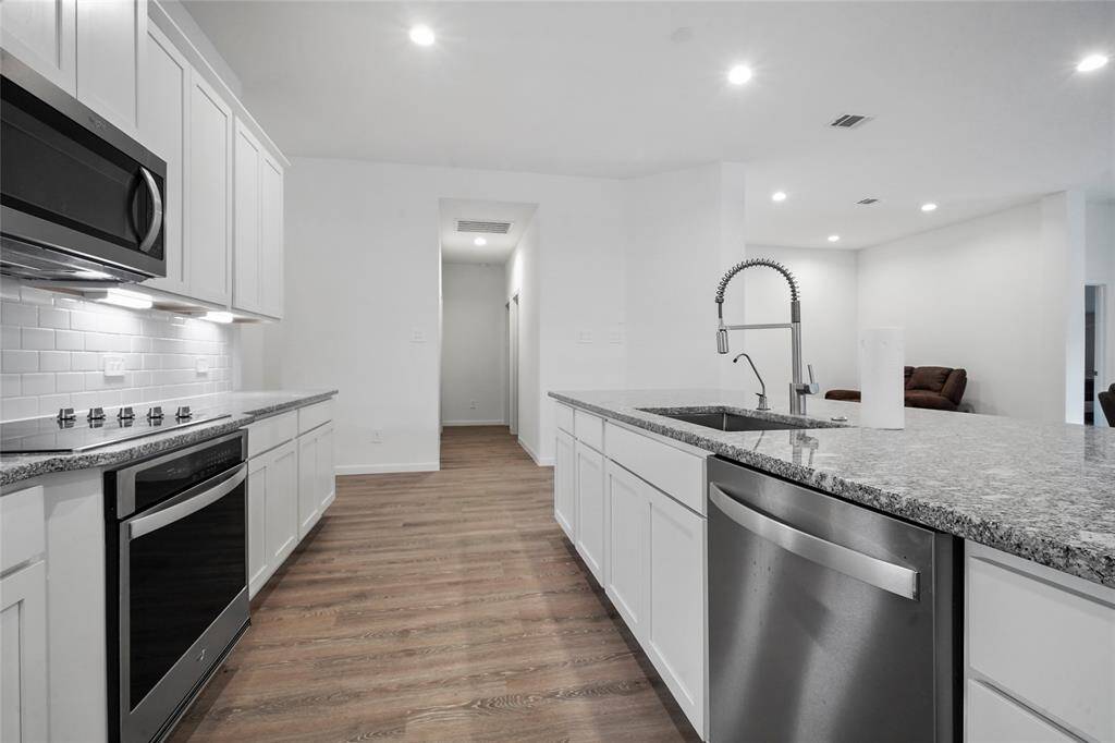 Notice the stainless appliances and single basin sink.