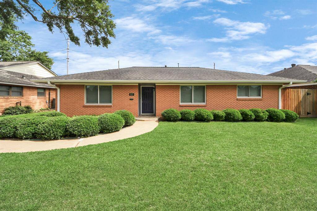 This charming single-story brick home features a well-maintained lawn, mature trees, and a welcoming pathway leading to the front door. Ideal for those seeking a cozy and inviting atmosphere.