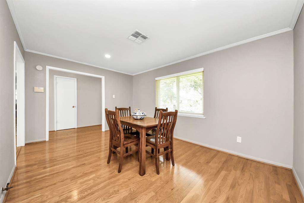 Elegant dining room with a warm, inviting ambiance, viewed from the entry hallway.