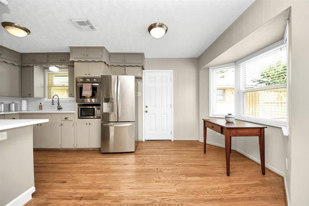 Enjoy serene backyard and patio views from the cozy breakfast nook.