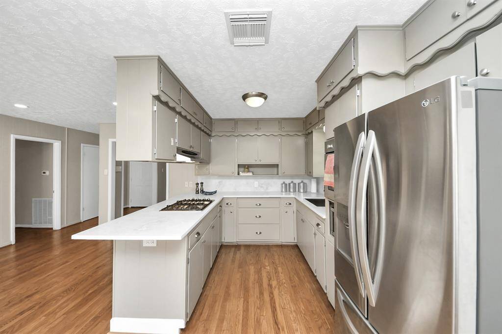 Modernized kitchen featuring freshly painted cabinets.