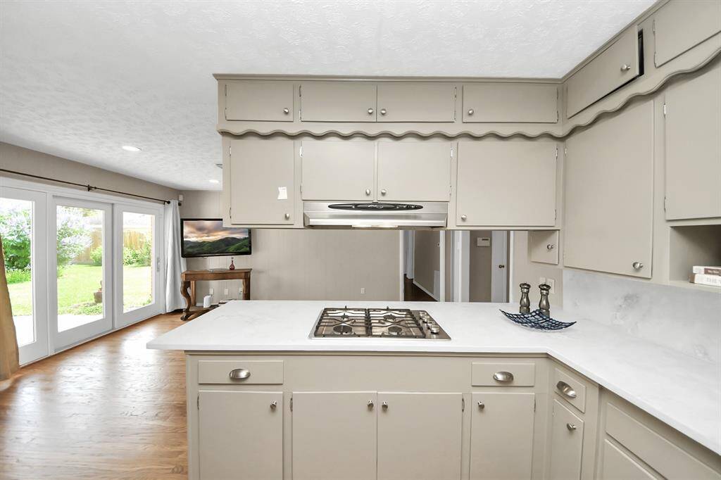 Enjoy cooking with a delightful view of the backyard and easy TV access.