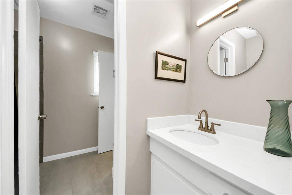 This half bath offers convenient access to a private tub and shower.