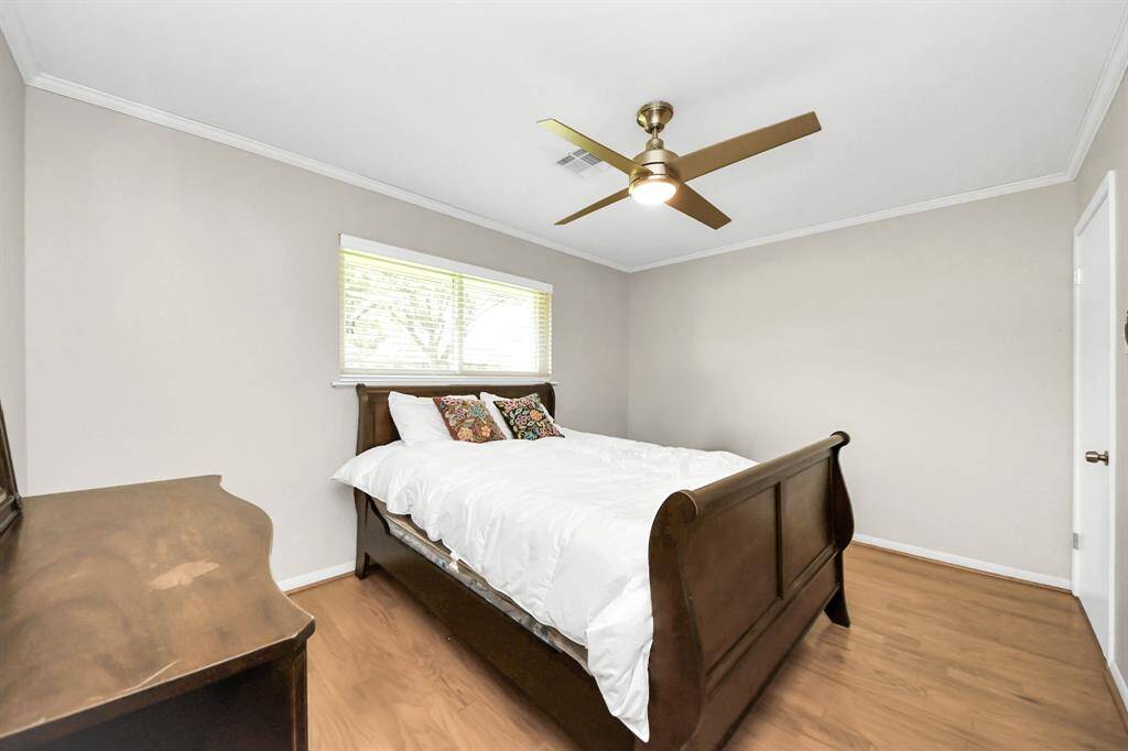 Experience comfort in Bedroom 2 with a convenient remote-controlled ceiling fan and light.