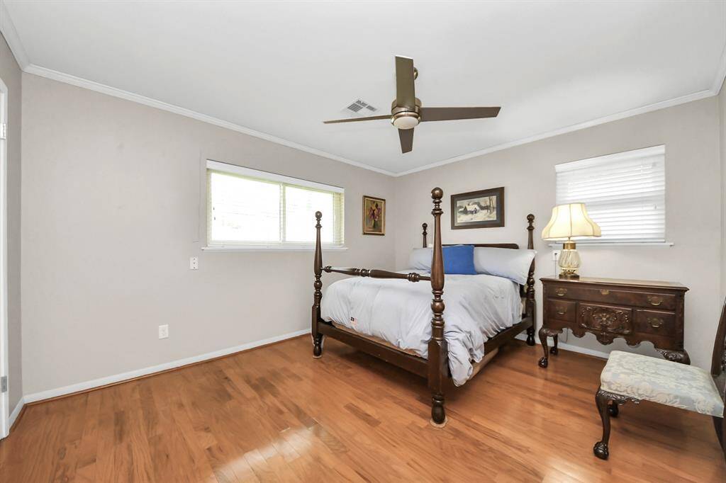 The master suite is filled with natural light, offers serene backyard views, and the soothing sounds of birds.