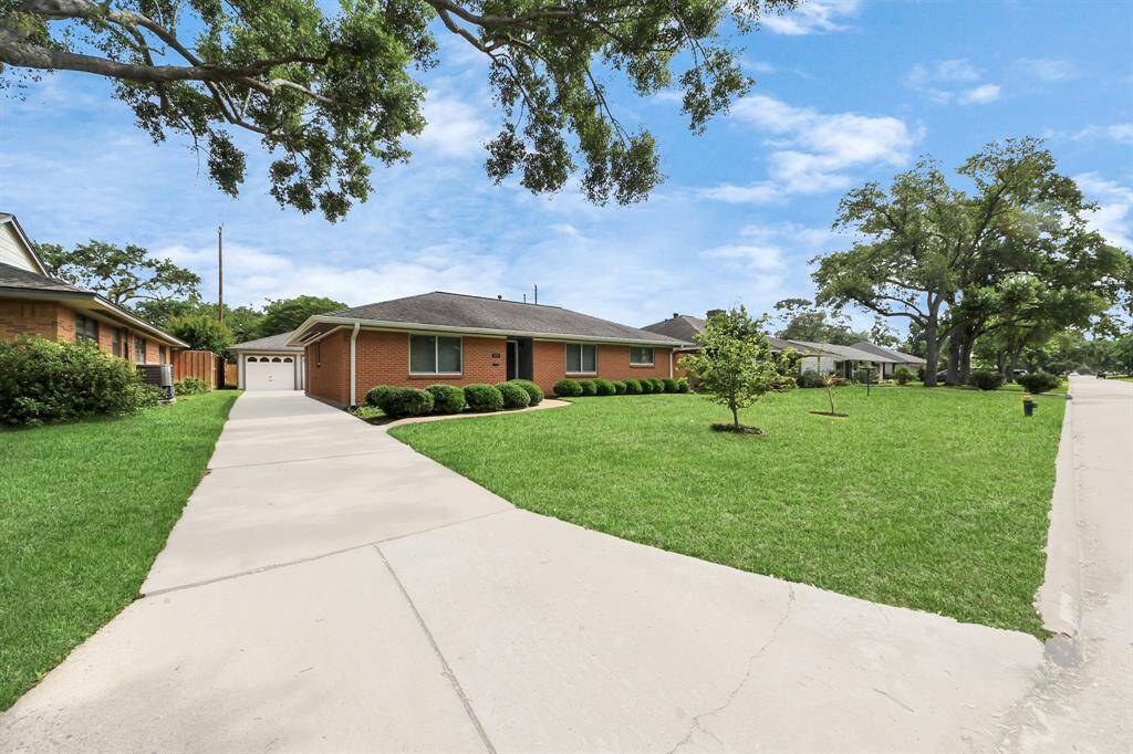 Convenient side driveway entry leads to the inviting kitchen, family room, and breakfast area.