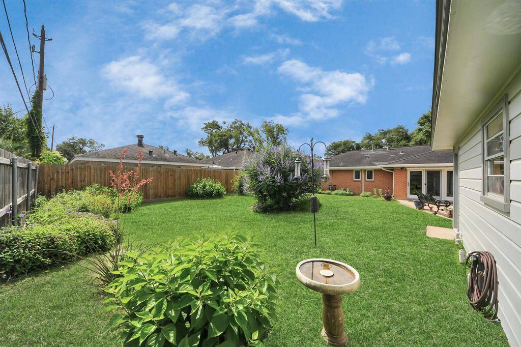 Charming exterior with lush landscaping.