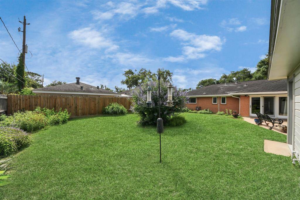 Expansive backyard with lush landscaping, perfect for relaxation and outdoor activities.