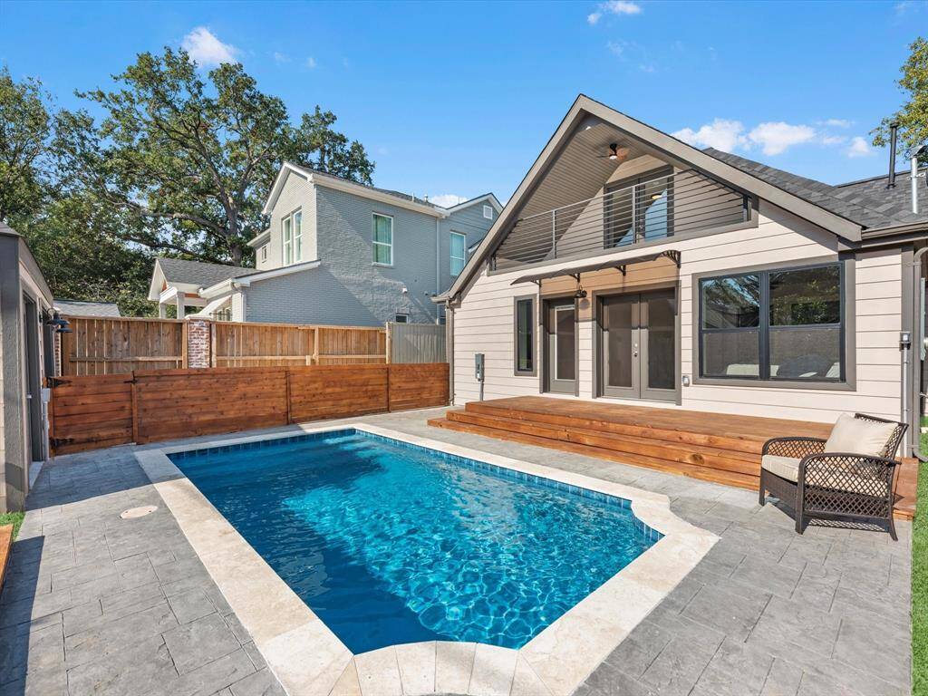 Welcome to 1819 Portsmouth St! Renovated pool with new decking and fencing, complemented by a covered awning and an upstairs balcony for added outdoor enjoyment.