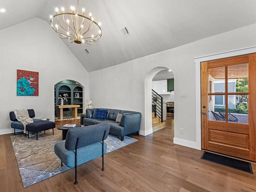 The main living area provides seamless access to the kitchen and a private study through elegant archways.