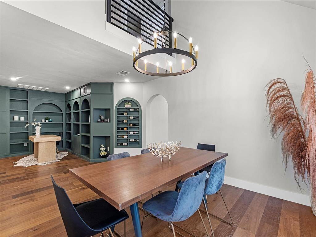 The upstairs loft area overlooks the spacious dining room, creating a dramatic open-to-below design and enhancing the home’s airy feel.