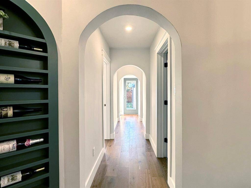 Elegant archways lead to luxurious bedrooms and a serene pool area, exuding timeless sophistication.