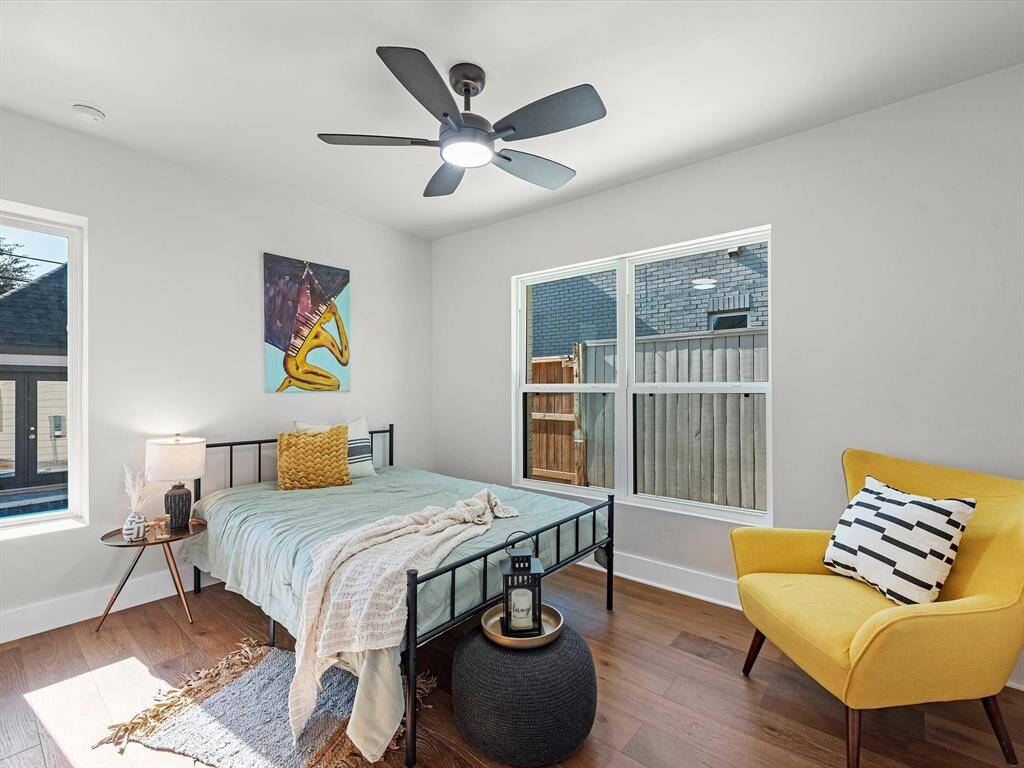 Bright and inviting first-floor secondary bedroom with abundant natural light and convenient access to the backyard.